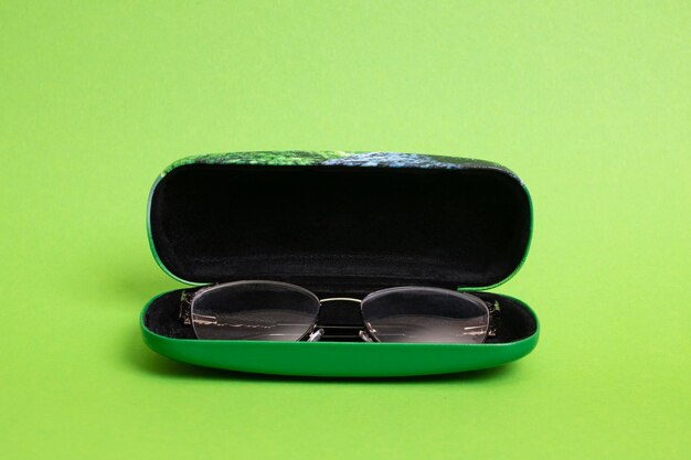 Case with glasses on a green background