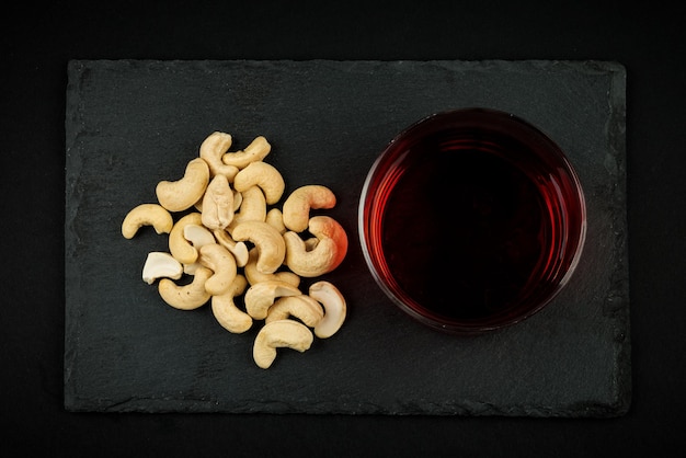 Cashew nuts appetizer with a glass of wine.