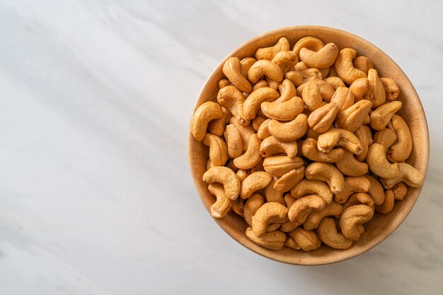 Cashew nuts in wooden bowl with copy space