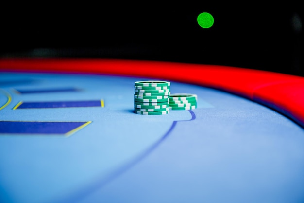 Casino chips colorful gaming pieces lie on the game table in the stack