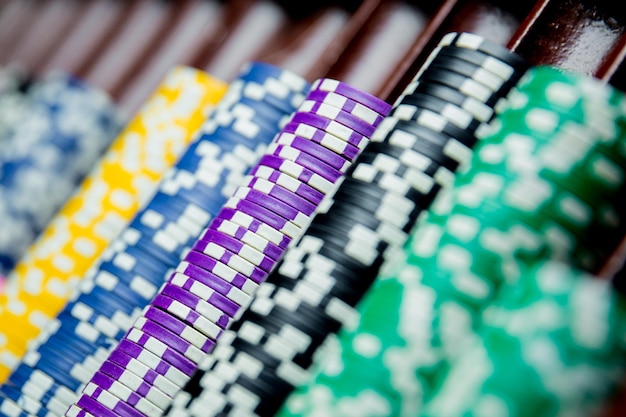 Casino chips colorful gaming pieces lie on the game table in the stack