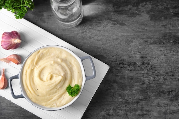 Casserole with mashed potatoes on wooden board