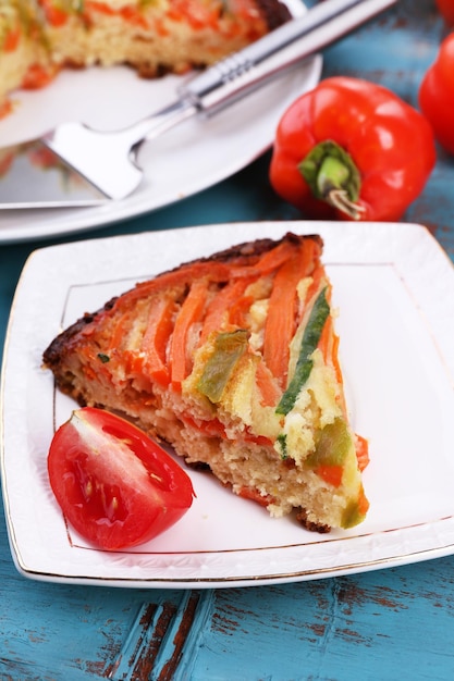 Casserole with vegetables on plate on table closeup