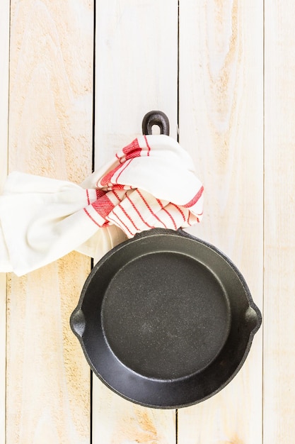 Cast iron skillet on rustic wood table.