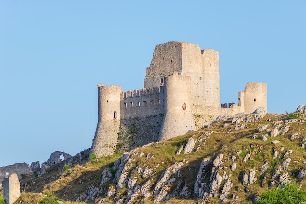 Castle ruins at Rocca Calascio italian travel destination landmark in the Gran Sasso National Park Abruzzo Italy Clear blue sky