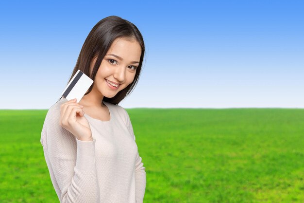 Casual business woman holding showing credit card smiling happy