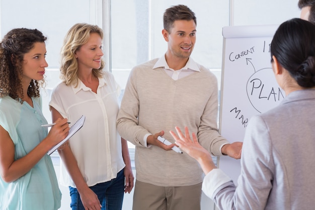 Casual businessman giving presentation to colleagues