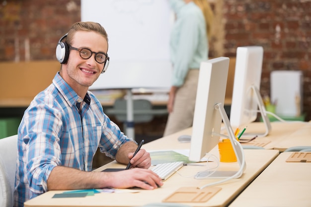 Casual male photo editor using digitizer in office