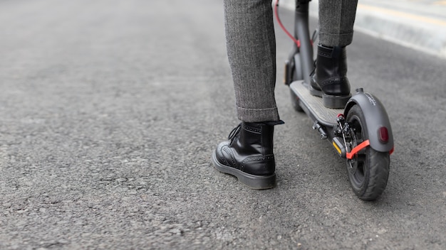 Casual male riding his scooter outdoors