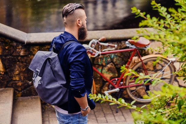 Casual modern guy with backpack. Back view.