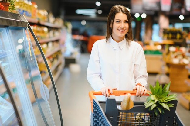 Casual woman grocery shopping and looking happy