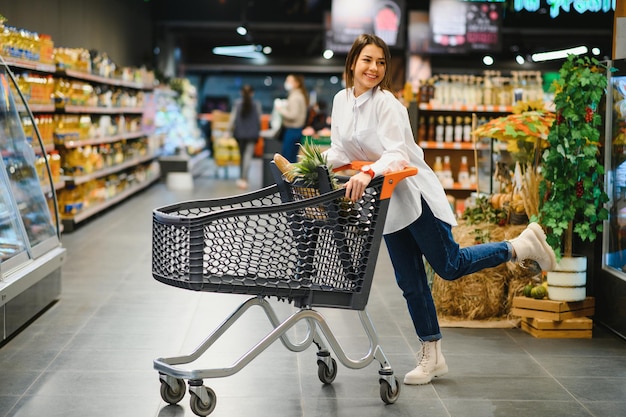 Casual woman grocery shopping and looking happy