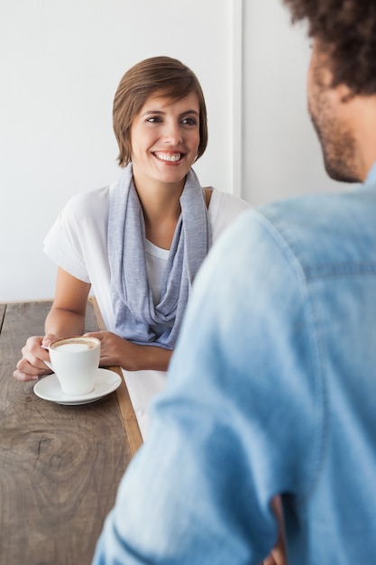 Casual woman having a coffee with friend