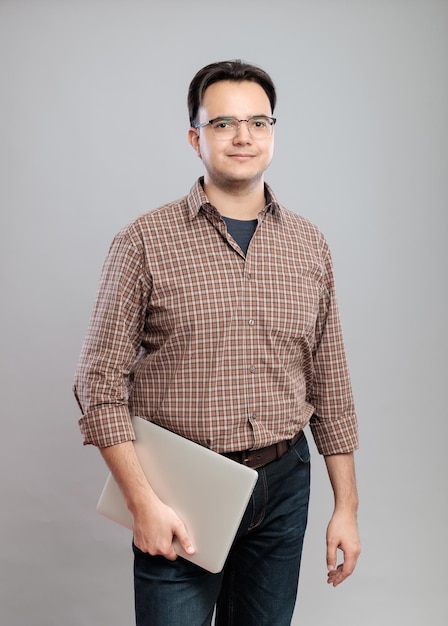 Casual young man in shirt with laptop