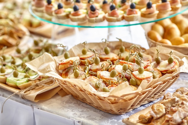 Catering of canape with olives, lemon and salmon