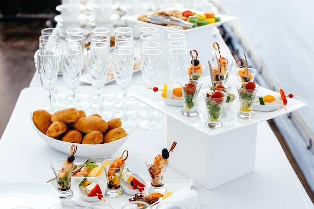 Catering food wedding white beautiful table Shrimp kebabs rolls