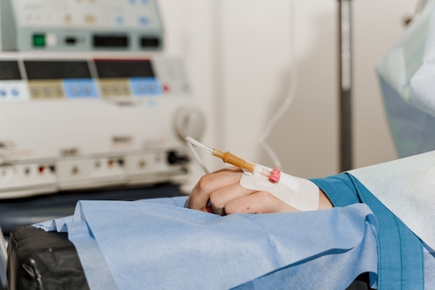 Catheter safely inserted into woman hand on plastic operation Anesthesia for surgery