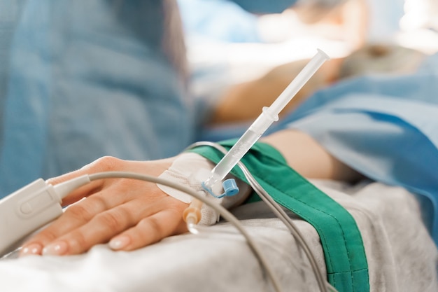 Catheter safely inserted into woman hand on plastic operation Anesthesia for surgery.