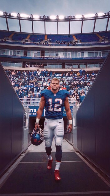 Caucasian American Football Player Walking Through a Dark Tunnel From a Big Outdoors Stadium Filled