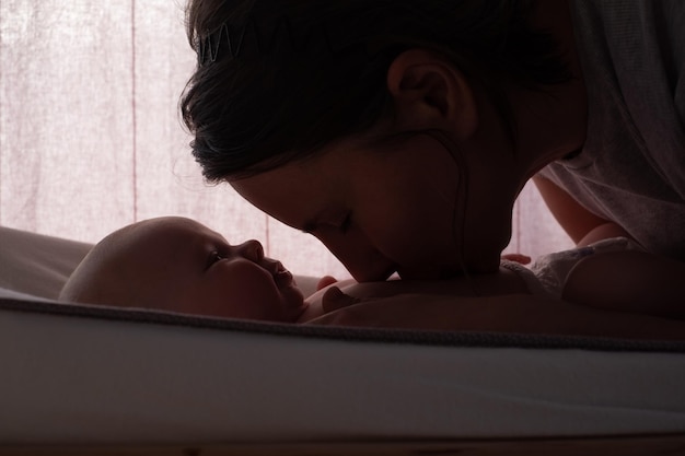 Caucasian baby looking on his mother smiling