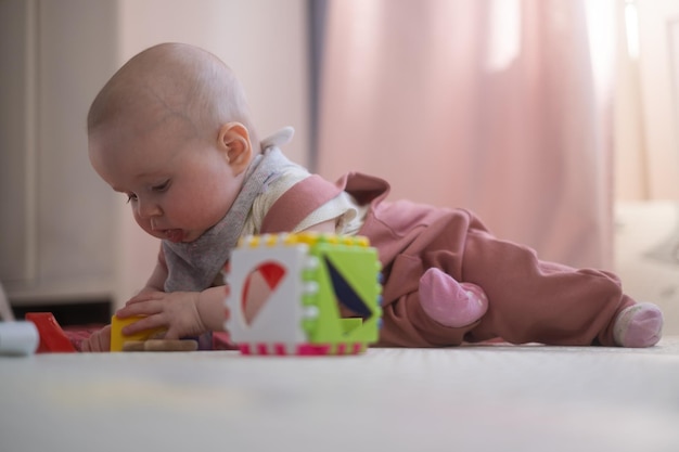 Caucasian baby toddler playing color blocks alone