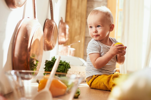 Caucasian beautiful toddler boy in the kitchen