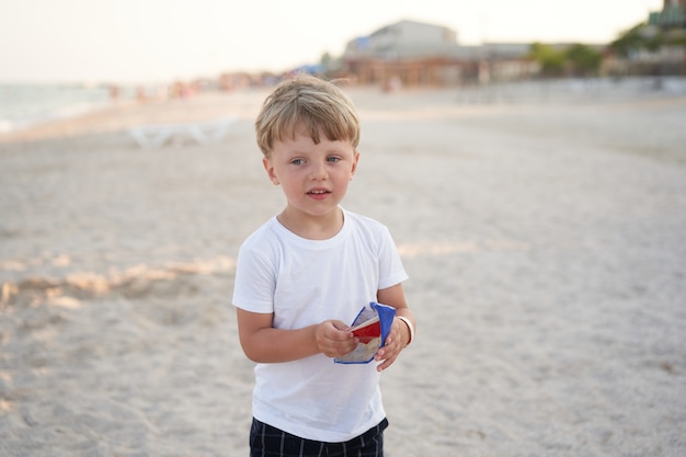 Caucasian boy standing on beach