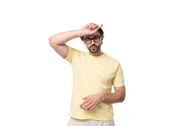 Caucasian brutal charming guy with a beard dressed in a summer tshirt on a white background with