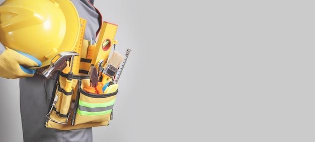 Caucasian building worker with a tool belt Construction tools