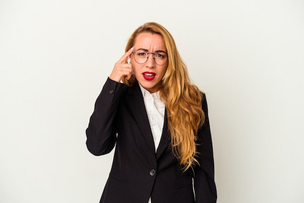 Caucasian business woman wearing a wireless headphones isolated on white background showing a disappointment gesture with forefinger.