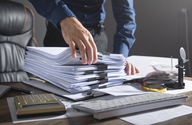 Caucasian businessman holding documents in office