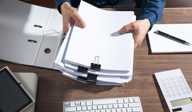 Caucasian businessman holding documents in office