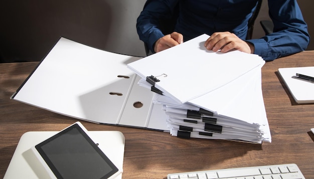 Caucasian businessman holding documents in office