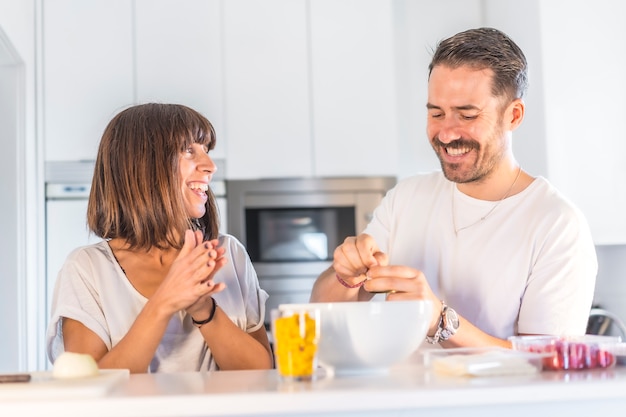 A Caucasian couple cooking together at home, cooking in confinement, cooking with the family. 