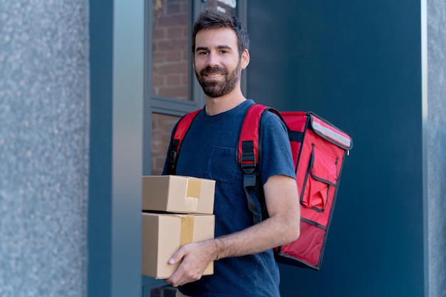 caucasian delivery man delivering parcel box. Courier service concept. horizontal view of happy rider delivering home a package.