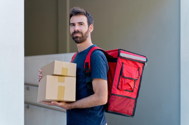 caucasian delivery man delivering parcel box. Courier service concept. horizontal view of happy rider delivering home a package.