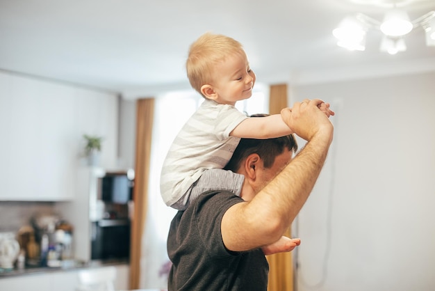 Caucasian father holdinf baby boy on shoulder Lifestyle family authentic concept Father's day