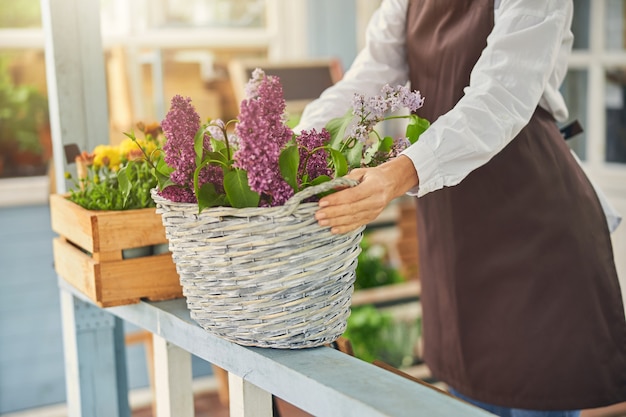 Caucasian female botanist taking care of flowers