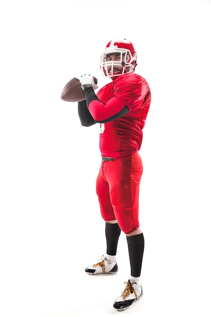 Caucasian fitness man as american football player holding a ball on white background