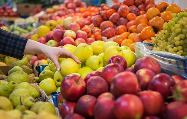 Caucasian girl buying fresh vegetables food products at the market