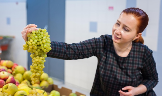 Caucasian girl buying fresh vegetables food products at the marketxA