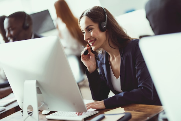 Caucasian girl looks at work in the call center.