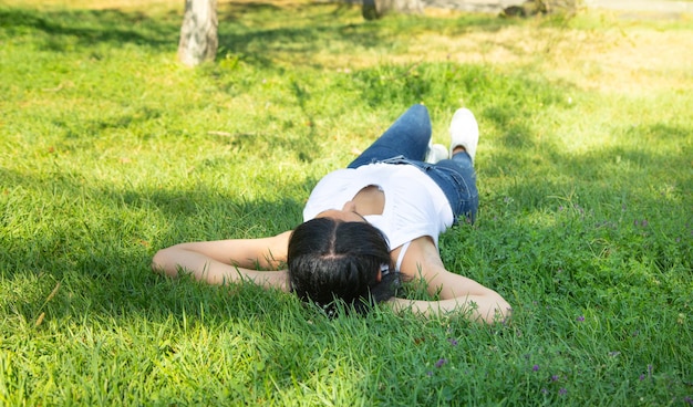 Caucasian girl lying on grass at the outdoor