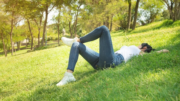 Caucasian girl lying on grass at the outdoor