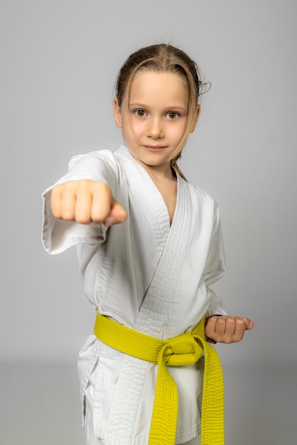 Caucasian girl practises karate studio shot