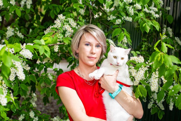 Caucasian girl walking in the park with her cat