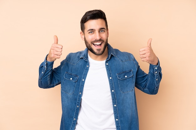 Caucasian handsome man isolated giving a thumbs up gesture