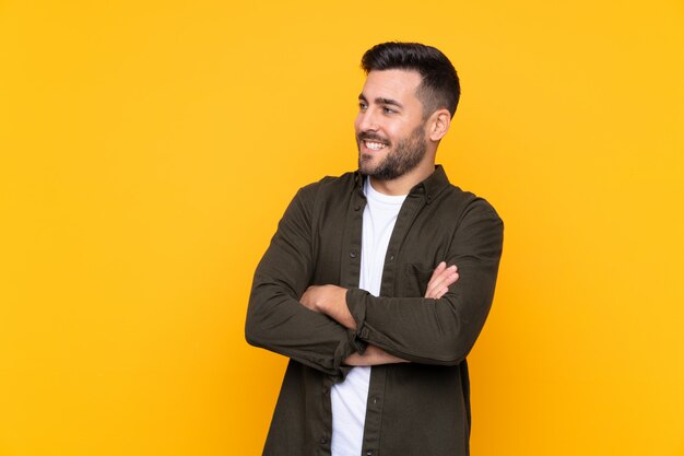 Caucasian handsome man over yellow wall