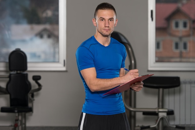 Caucasian Instructor Takes Notes On Clipboard