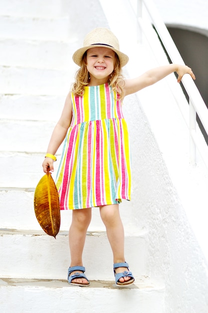 Caucasian Little Blond Girl posing with summer clothes